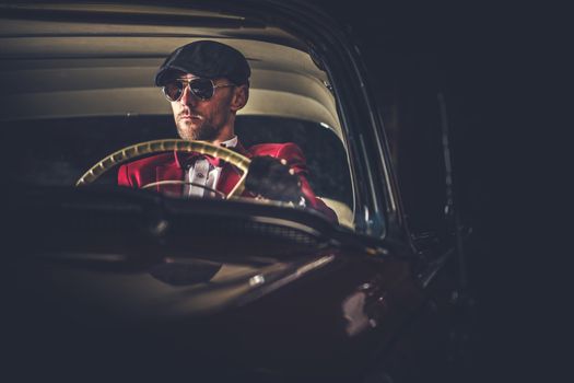Elegant Caucasian Vintage Car Driver in Sunglasses. Passionate Driving His Classic Car.