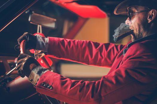 Happy Cowboy Millionaire in His 30s with Burning Cigar in the Vintage Classic Car. American Dream Come True. Lucky Jackpot Winner Leaving Las Vegas.