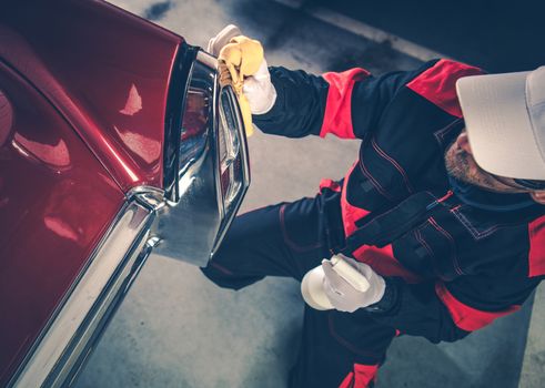 Caucasian Men in His 30s Detailing His Classic Car Using Body Protection Liquid. American Collectible Vehicle. Deep Automobile Cleaning.