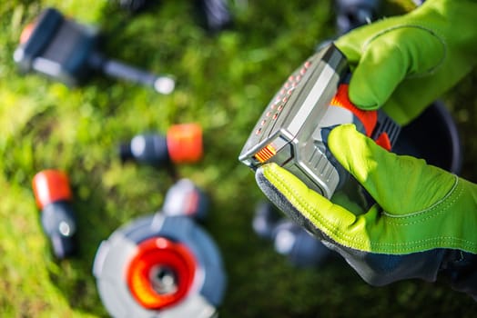 Water Sprayer Head in Hands of Gardener. Building Professional Garden Watering System.