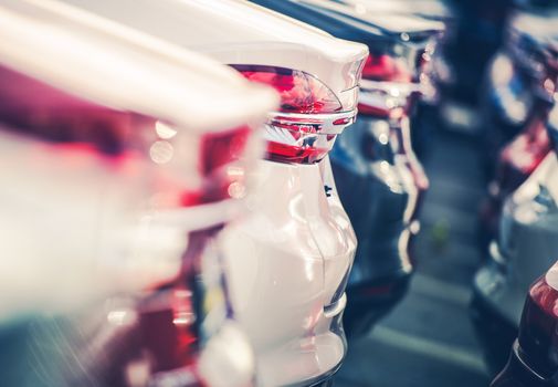 New Cars in Dealer Stock. Brand New Vehicles For Sale. Closeup Photo with Shallow Depth of Field. Transportation and Automotive Industry.