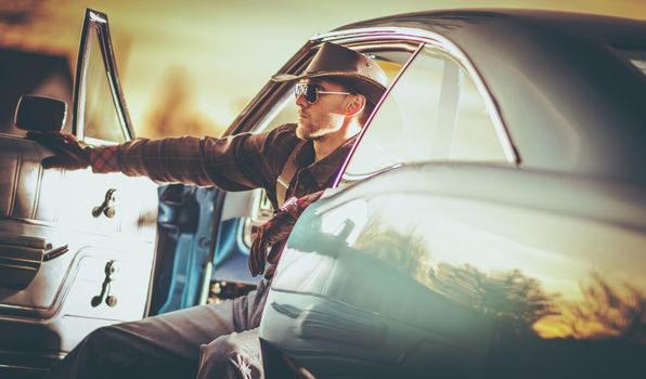 American Classic Muscle Car Cowboy Driver in His 30s. Wester Wear Outlaw Style.