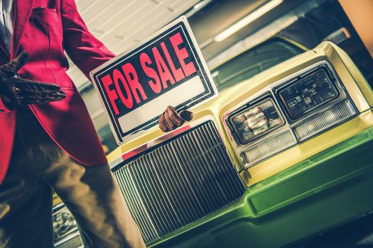 Car For Sale Sign in a Hand of Car Seller. Automotive Dealership Theme.