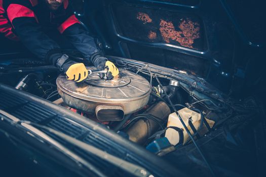 Classic Car Maintenance by Professional Car Mechanic. Worker Finishing Air Filter Change.