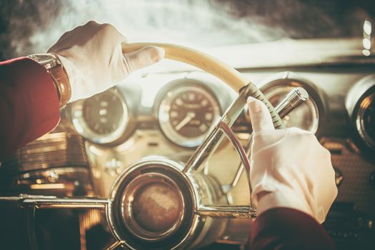 Classic Retro Car Driver. Men in White Gloves Driving His Vintage Vehicle. Steering Wheel Closeup.