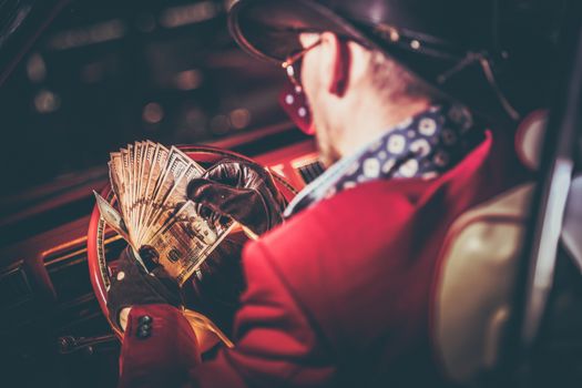 Lucky Casino Winner with His Cash Jackpot in Hands. American Cowboy and the Classic Car. Las Vegas Trip.