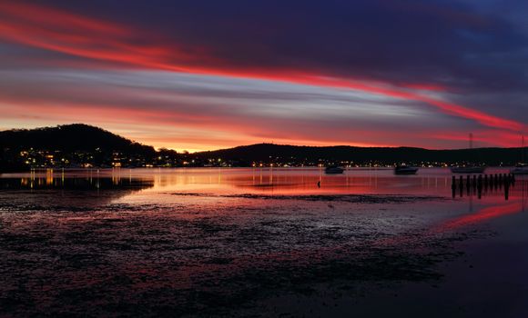 Lingering colour in the evening skies over Yattalunga and reflections in the tidal estruary.  A long exposure with some motion 