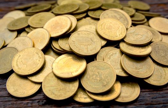 Saving money with stack of coin growing for business and accounting concept on wooden background.