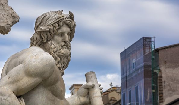 Marble head of River Ganges statue as a greek god, detail from baroque Fountain of Four River in the center of Piazza Navona Square, Rome (17 th century)