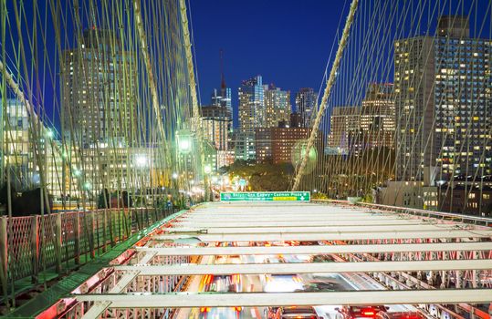 Brooklyn Bridge at night with car traffic