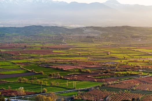 Aerial view of beutiful sunset over green and red agricultiral fields near Pamukkale in Turkey