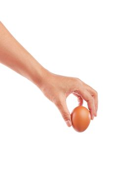 female teen hand holding brown chicken egg isolated on white background, Save clipping path.