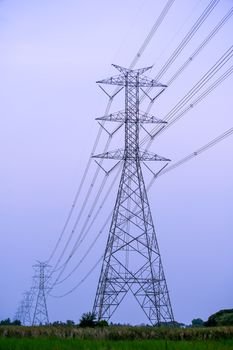 high voltage power lines during fiery sunset