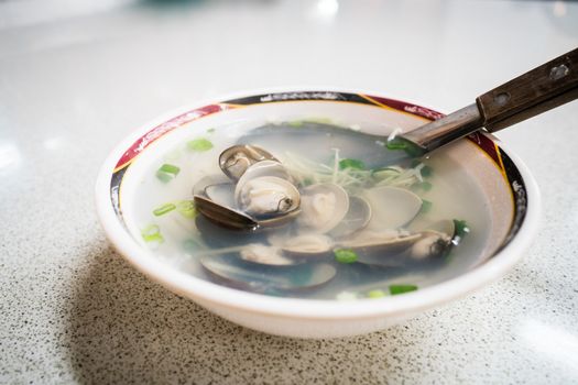 A bowl of Taiwanese clam soup in a night market restaurant.