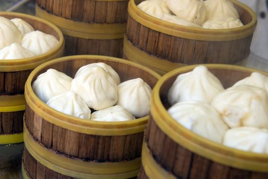 Chinese style white bun in dumpling wooden steamer