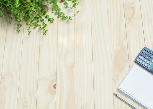 Top view of pen with calculator and notebook on wooden table and copy space for insert text.