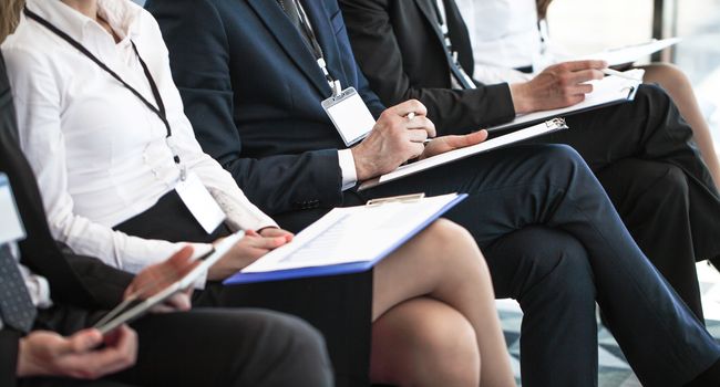 Audience of business people at conference or seminar