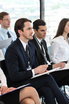 Audience of business people at conference or seminar