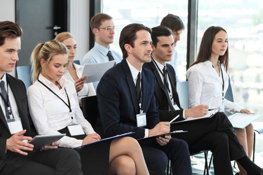 Audience of business people at conference or seminar