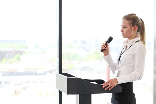 Businesswoman giving a presentation to audience