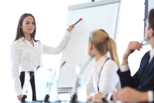 Group of speakers at business meeting at the table with microphones