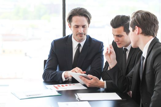 Business people using tablet pc together at office