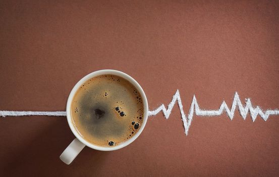 Coffee cup top view and heart beats cardiogram from sugar