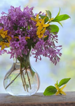 Spring Lilac bouquet on the wooden table