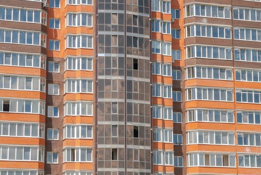 kind of a new multistorey brick residential building on a sunny day