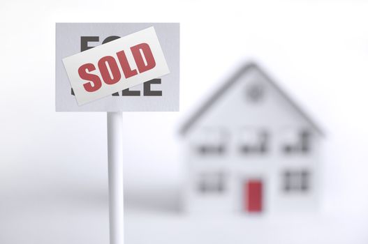 Sold sign in front of a model house