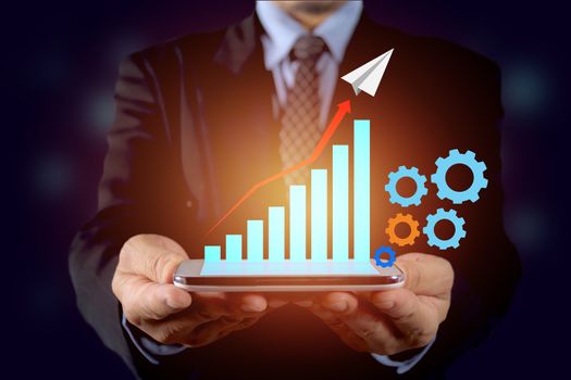 Double exposure stock financial indices with smart phone and businessman. Financial stock market in accounting market economy analysis. Hand holding smart phone blue touchscreen.
