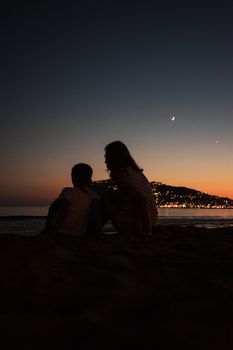 mother and son on the pier in the evening at Alania, Turkey