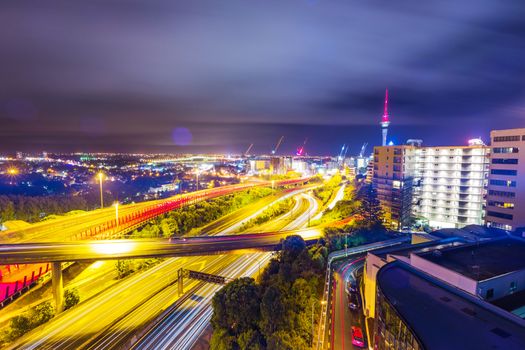 Long exposure shot of Auckland New Zealand transport at night with sky tower