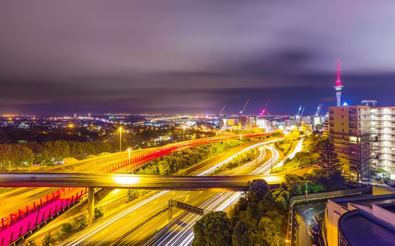 Long exposure shot of Auckland New Zealand transport at night with sky tower