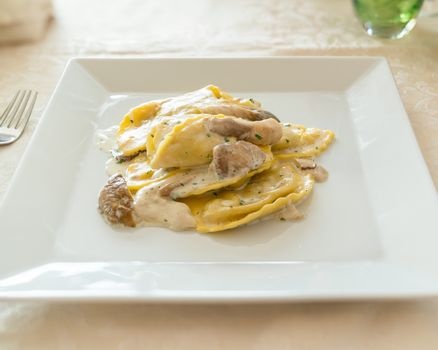 Italian ravioli tortellini with Porcini mushrooms, cream sauce, parsley,at restaurant.