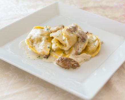 Italian ravioli tortellini with Porcini mushrooms, cream sauce, parsley,at restaurant.