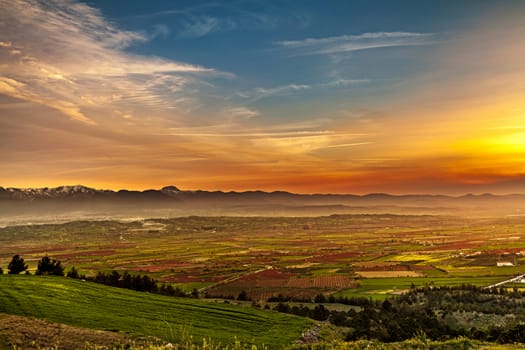 Aerial view of beutiful sunset over green and red agricultiral fields near Pamukkale in Turkey