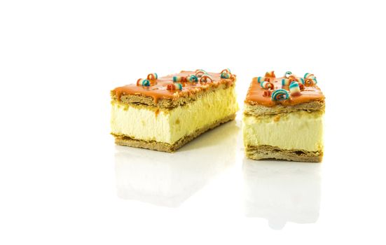 two orange tompouce, the traditional dutch pastry , mostly on kingsday, therefore the color is orange, the dutch traditional color