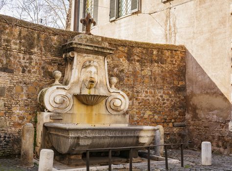 Fountain in Via Giulia, known as mascherone, representing a human face