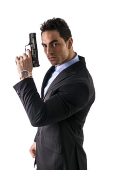 Elegant man with gun, dressed as a spy or secret agent, isolated on white