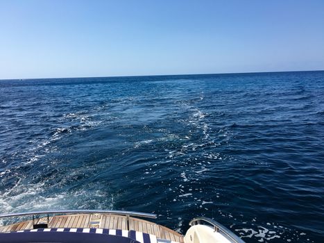 view from the boat behind to the ocean