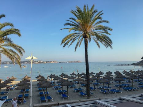 an empty beach in monaco with deck chairs in front