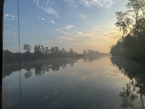 venice canal with fog and reflection at sunrise in summer