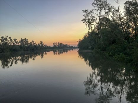 venice canal with fog and reflection at sunrise in summer