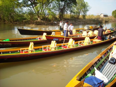 fishers with his boats at a river in burma