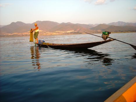 a fisher is preparing his trap in burma