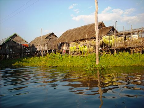 a fishers house at the river in burma