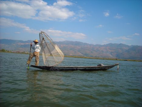 a fisher is looking for fishes in his boat
