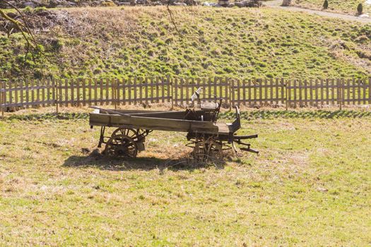 an old horse drawn carriage in a lonely field