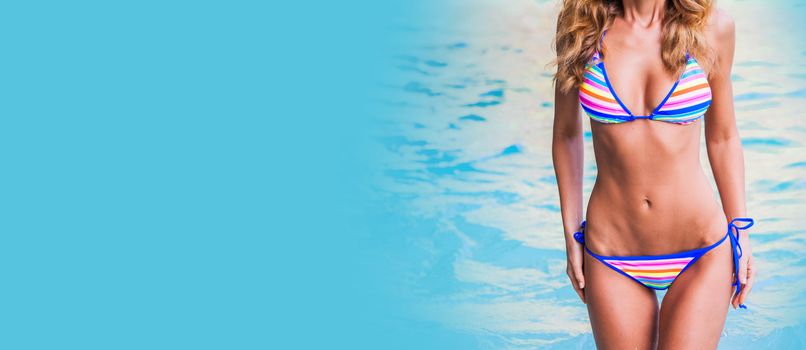 Tanned woman body in bikini, blue sea water in background